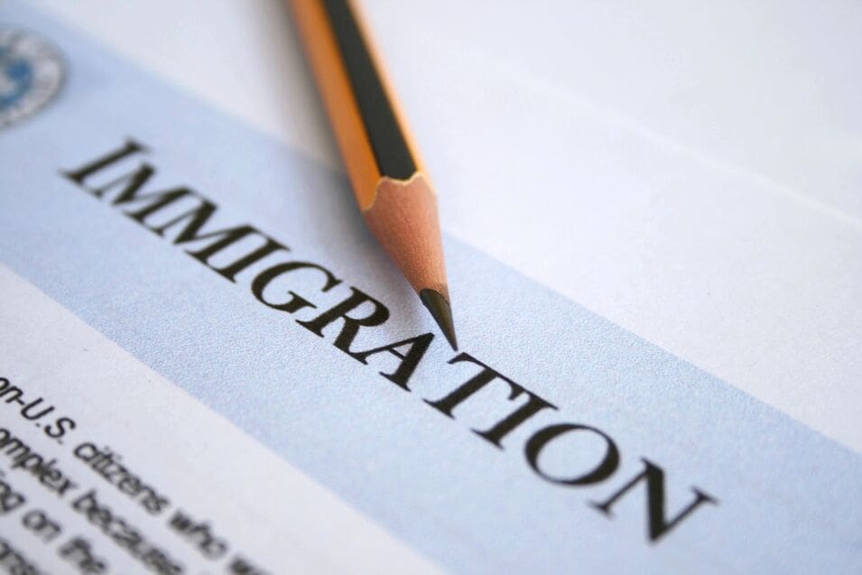 A pencil is on top of the word immigration.